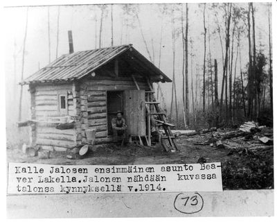 Kalle Jalo sitting on doorstep of his first house at Beaver Lake - 1914
